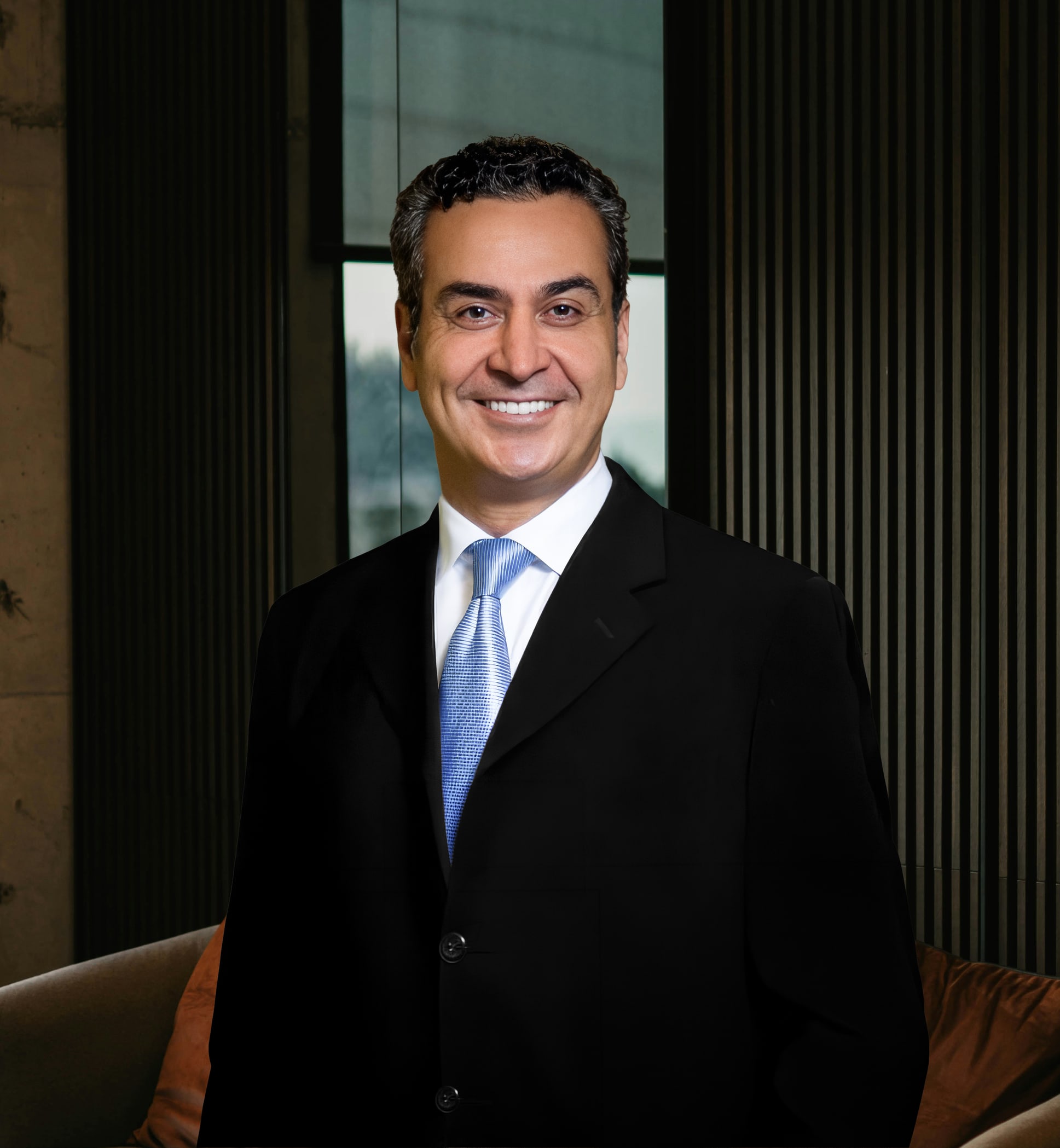 Dr. Jay M. Shenaq in a dark suit and blue tie
